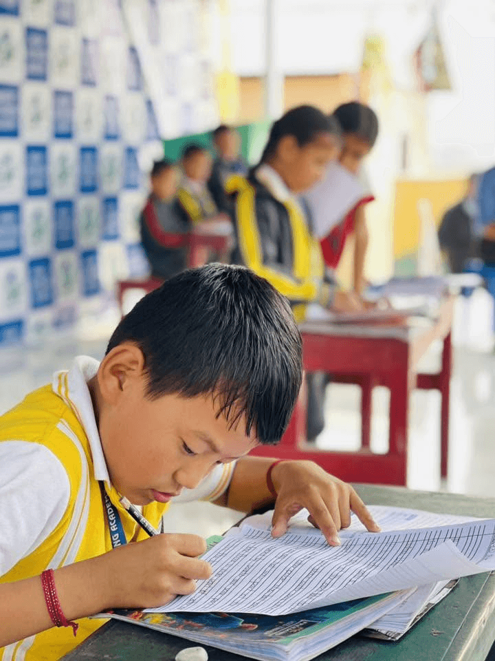 A student concentrating while writing in class